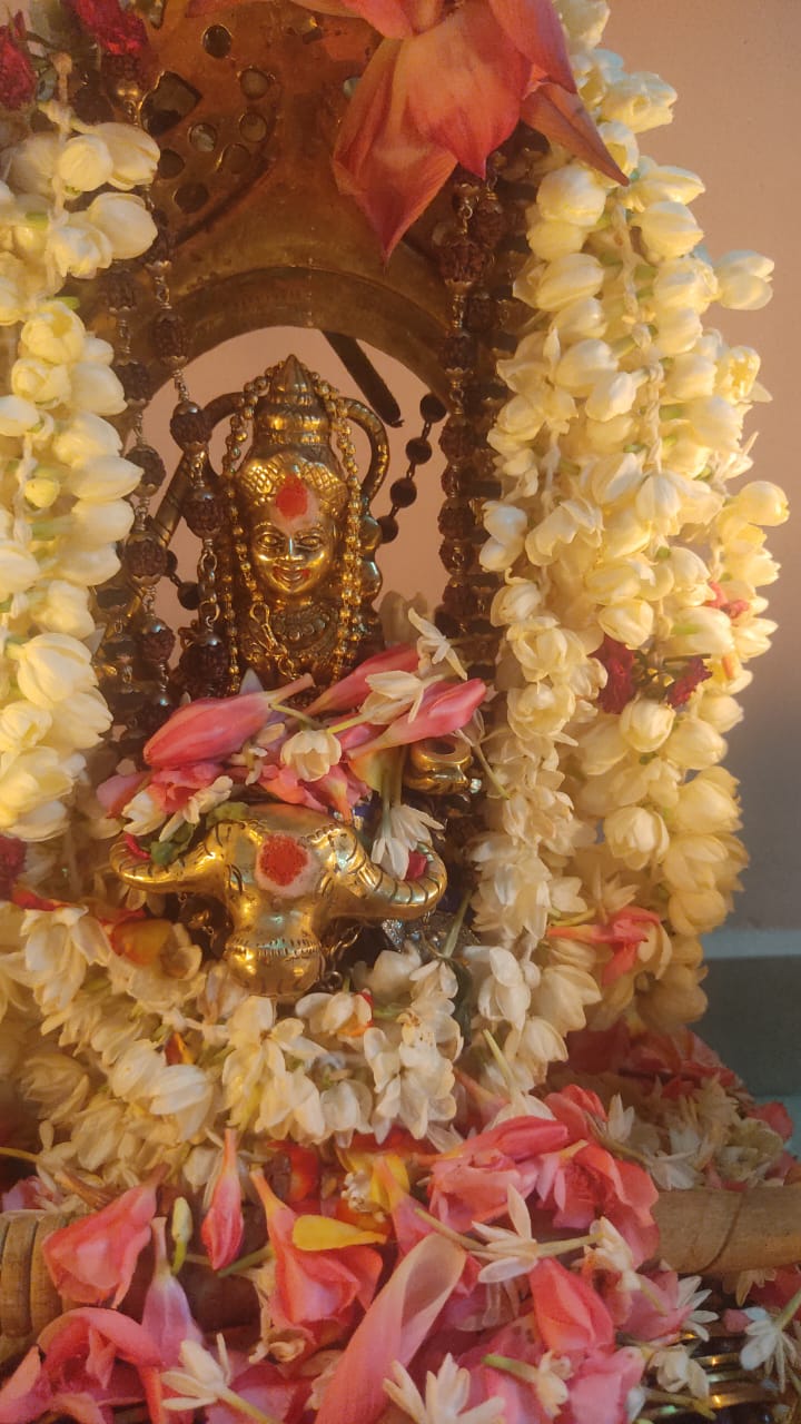 Temple deity adorned with flowers