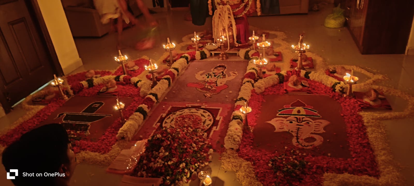 Ritual altar with lamps and floral arrangement