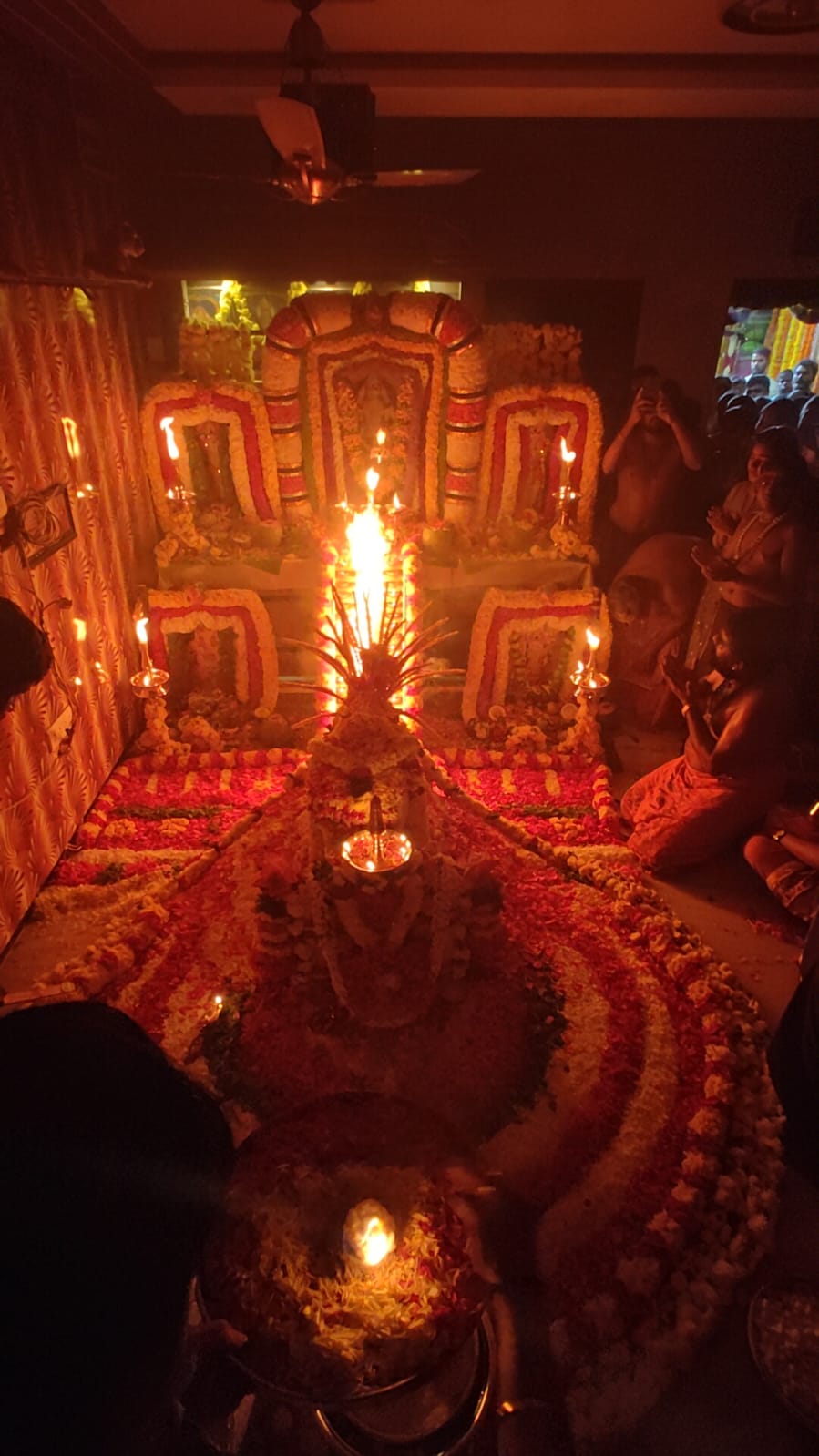 Temple ritual with central fire and devotees