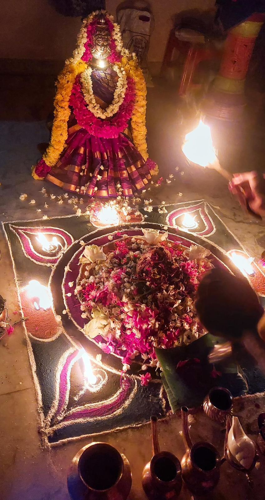 Pooja arrangement with lamps and flowers